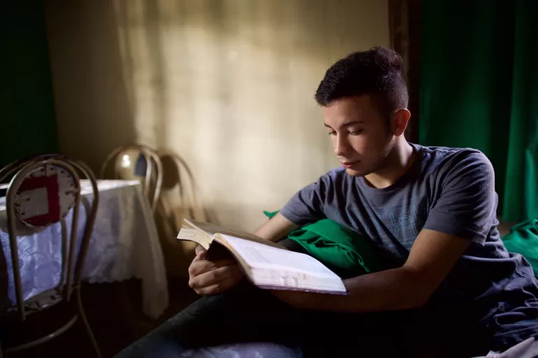 A young man studying scriptures